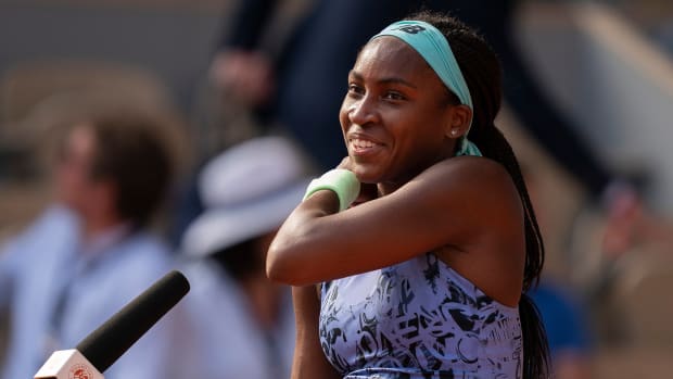 Coco Gauff speaking at a microphone at the French Open